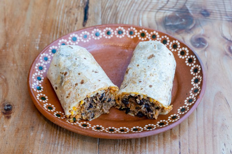 Homemade Costa Vida-style burrito with fresh salsa and lime